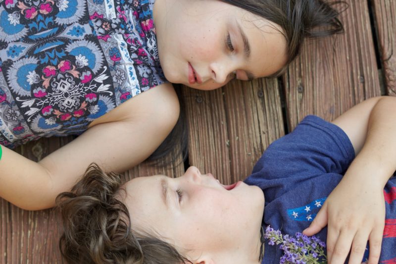 two small kids on wooden deck