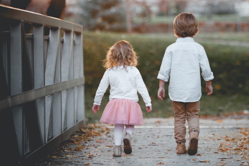 little boy and girl walking away